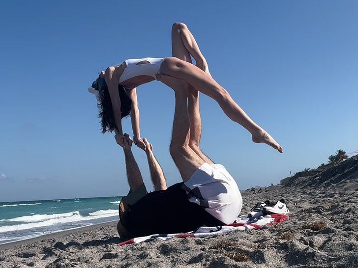 c79f1dc08e524bf6a544e27acdcb799e_md Bill Belichick, GF Jordon Hudson Perform Acrobatic Stunts on Beach