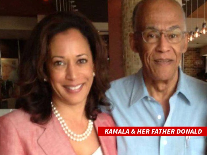 Kamala Harris smiling in a blazer and pearl necklace while standing to the right of her father, Donald Harris.