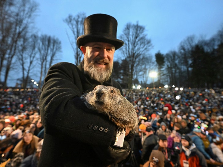 7b438c7dfb5949f98118209a8392cf82_md Groundhog Club handler AJ Dereume holds Punxsutawney Phil
