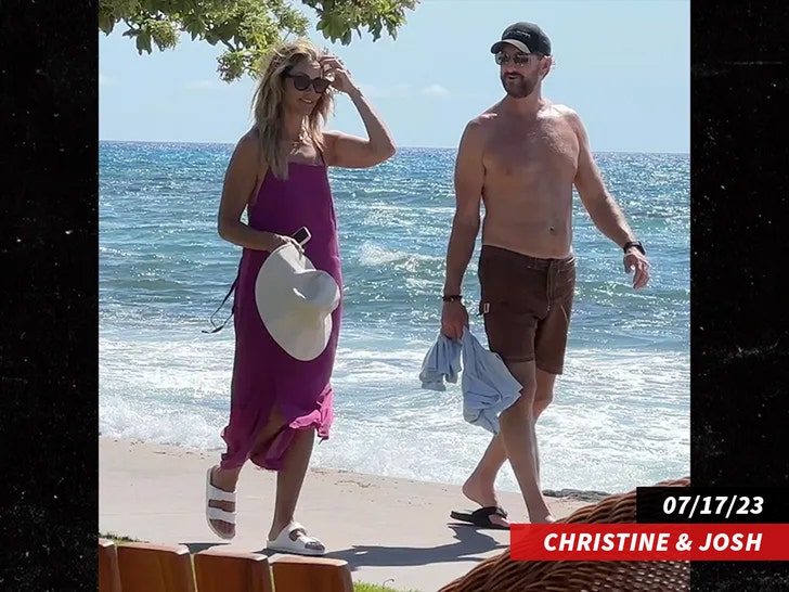 Christine Baumgartner and Josh Connor walking on beach in Hawaii