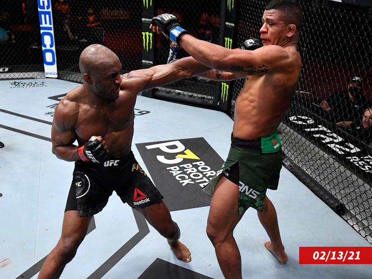 Kamaru Usman of Nigeria punches Gilbert Burns