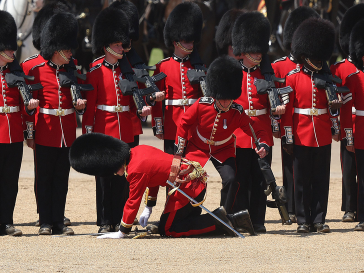 Grenadier Guards is carried after fainting during the Colonel's Review
