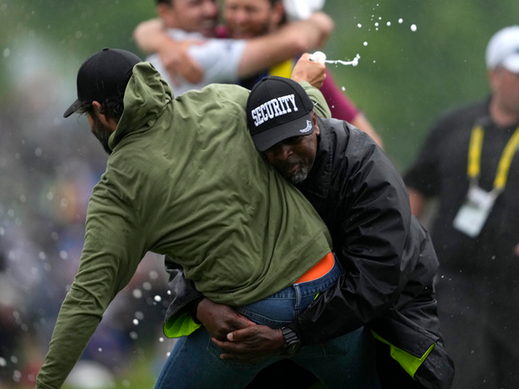 061123 adam hadwin tackled - AP