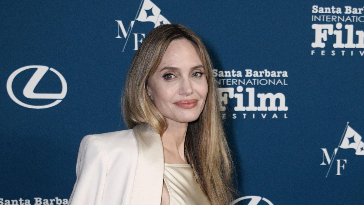 Jolie is said to be coping by traveling to conflict zones amid mounting personal pressure.